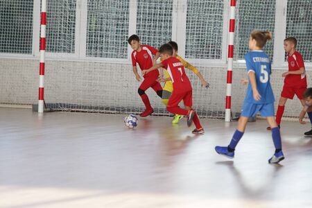 Odessa, Ukraine-December 12, 2019: Little boys, children play mini football in sports hall at sports city Junior championship. Children's sport is healthy lifestyle. Sports children football playersのeditorial素材