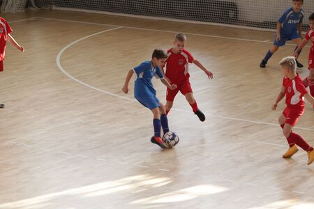 Odessa, Ukraine-December 12, 2019: Little boys, children play mini football in sports hall at sports city Junior championship. Children's sport is healthy lifestyle. Sports children football playersのeditorial素材