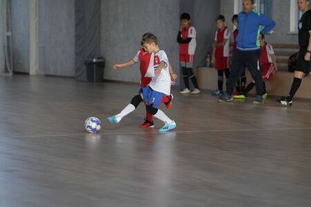 Odessa, Ukraine-December 12, 2019: Little boys, children play mini football in sports hall at sports city Junior championship. Children's sport is healthy lifestyle. Sports children football playersのeditorial素材