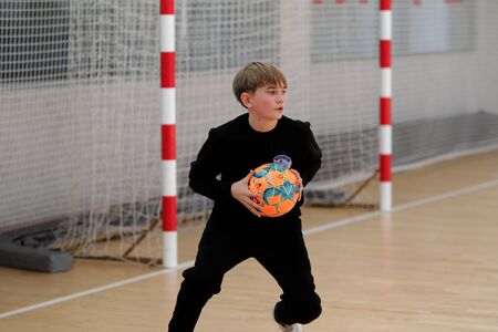 Odessa, Ukraine- Febr 17, 2020: Little boys, children play mini football in sports hall at sports...