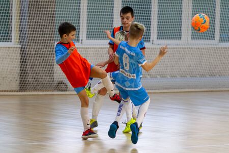 Odessa, Ukraine- Febr 17, 2020: Little boys, children play mini football in sports hall at sports city Junior championship. Children's sport is healthy lifestyle. Sports children football playersのeditorial素材
