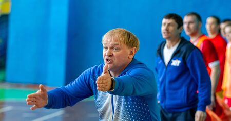 ODESSA, UKRAINE - CIRKA, 2020: domestic football. Footballers of local team play futsal mini-tournament. Acute tense moment of sports soccer match in an indoor hallのeditorial素材