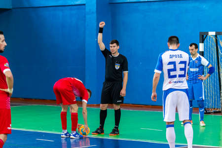 ODESSA, UKRAINE - CIRKA, 2020: domestic football. Footballers of local team play futsal mini-tournament. Acute tense moment of sports soccer match in an indoor hallのeditorial素材