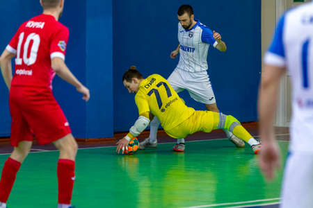 ODESSA, UKRAINE - CIRKA, 2020: domestic football. Footballers of local team play futsal mini-tournament. Acute tense moment of sports soccer match in an indoor hallのeditorial素材