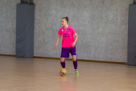 ODESSA, UKRAINE - March 13, 2020: Futsal Cup of Ukraine, futsal among students. During final match in futsal among student teams. Beautiful sports girls play mini football on parquet floorのeditorial素材