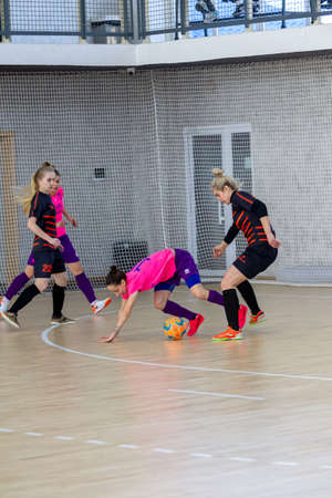 ODESSA, UKRAINE - March 13, 2020: Futsal Cup of Ukraine, futsal among students. During final match in futsal among student teams. Beautiful sports girls play mini football on parquet floorのeditorial素材