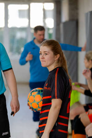 ODESSA, UKRAINE - March 13, 2020: Futsal Cup of Ukraine, futsal among students. During final match in futsal among student teams. Beautiful sports girls play mini football on parquet floorのeditorial素材