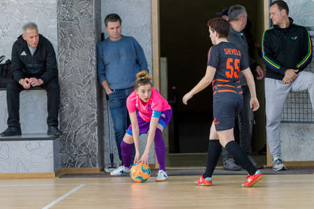 ODESSA, UKRAINE - March 13, 2020: Futsal Cup of Ukraine, futsal among students. During final match in futsal among student teams. Beautiful sports girls play mini football on parquet floorのeditorial素材