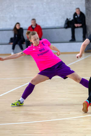 ODESSA, UKRAINE - March 13, 2020: Futsal Cup of Ukraine, futsal among students. During final match in futsal among student teams. Beautiful sports girls play mini football on parquet floorのeditorial素材