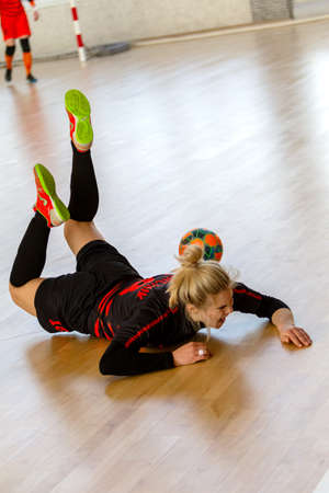 ODESSA, UKRAINE - March 13, 2020: Futsal Cup of Ukraine, futsal among students. During final match in futsal among student teams. Beautiful sports girls play mini football on parquet floorのeditorial素材