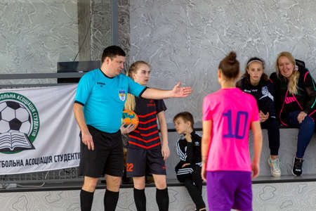 ODESSA, UKRAINE - March 13, 2020: Futsal Cup of Ukraine, futsal among students. During final match in futsal among student teams. Beautiful sports girls play mini football on parquet floorのeditorial素材