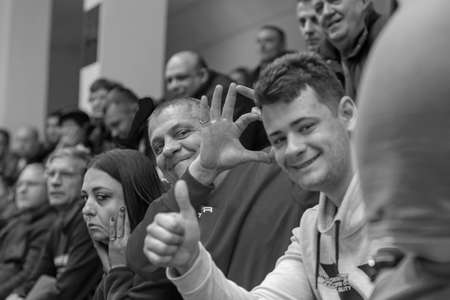 KAMENSKY, Ukraine - February 14, 2020. Sports spectators, fans do not support their team during women's volleyball tournament. Sports fans, ultras on grandstandのeditorial素材