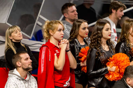 KAMENSKY, Ukraine - February 14, 2020. Sports spectators, fans do not support their team during women's volleyball tournament. Sports fans, ultras on grandstandのeditorial素材