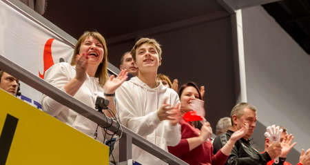 KAMENSKY, Ukraine - February 14, 2020. Sports spectators, fans do not support their team during women's volleyball tournament. Sports fans, ultras on grandstandのeditorial素材