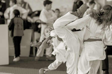 Odessa, Ukraine - September 30, 2019: Karate Championship among children of athletes. The best karate fighters children girls demonstrate their ability to fight on tatami. Battle of karate young girlsのeditorial素材