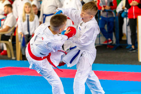 Odessa, Ukraine - September 30, 2019: Karate Championship among children of athletes. Best karate fighters children demonstrate their ability to fight on tatami. Battle of karate. Children's sportsのeditorial素材