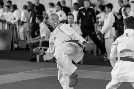 Odessa, Ukraine - September 30, 2019: Karate Championship among children of athletes. Best karate fighters children demonstrate their ability to fight on tatami. Battle of karate. Children's sportsのeditorial素材