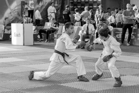 Odessa, Ukraine - September 30, 2019: Karate Championship among children of athletes. Best karate fighters children demonstrate their ability to fight on tatami. Battle of karate. Children's sportsのeditorial素材