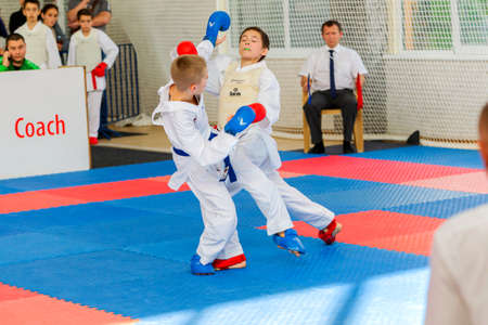 Odessa, Ukraine - September 30, 2019: Karate Championship among children of athletes. Best karate fighters children demonstrate their ability to fight on tatami. Battle of karate. Children's sportsのeditorial素材