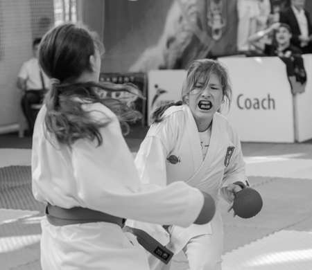 Odessa, Ukraine - September 30, 2019: Karate Championship among children of athletes. The best karate fighters children girls demonstrate their ability to fight on tatami. Battle of karate young girlsのeditorial素材