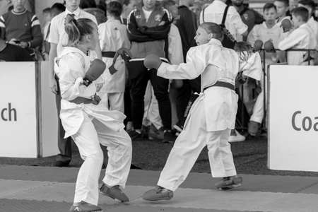 Odessa, Ukraine - September 30, 2019: Karate Championship among children of athletes. The best karate fighters children girls demonstrate their ability to fight on tatami. Battle of karate young girlsのeditorial素材