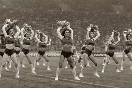 ODESSA, UKRAINE - July28, 2019: Performance of beautiful young girls cheerleader team during opening of football championship. Team performance cheerleader on grass field stadium. Girls of cheerleaderのeditorial素材