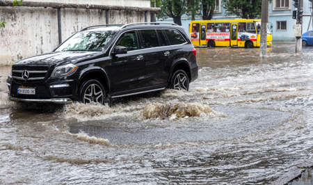 Odessa, Ukraine - May 28, 2020: driving car on flooded road during flood caused by torrential rains....