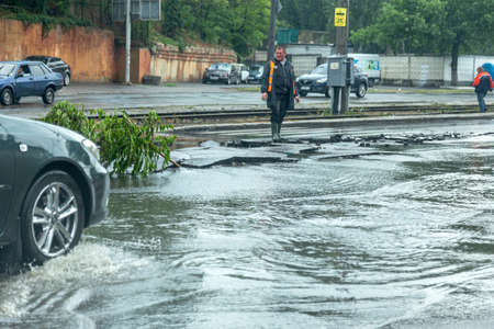 Odessa, Ukraine - May 28, 2020: driving car on flooded road during flood caused by torrential rains....