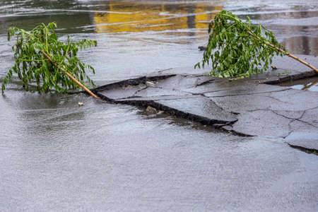 Odessa, Ukraine - May 28, 2020: driving car on flooded road during flood caused by torrential rains. Cars float on water, flooding streets. Splash on car. Flooded city road with large puddleのeditorial素材