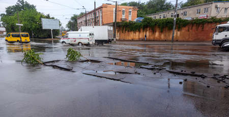 Odessa, Ukraine - May 28, 2020: driving car on flooded road during flood caused by torrential rains. Cars float on water, flooding streets. Splash on car. Flooded city road with large puddleのeditorial素材