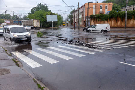 Odessa, Ukraine - May 28, 2020: driving car on flooded road during flood caused by torrential rains....