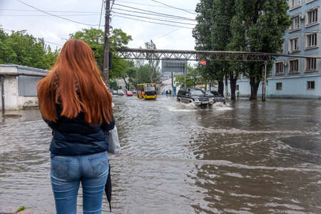 Odessa, Ukraine - May 28, 2020: driving car on flooded road during flood caused by torrential rains....