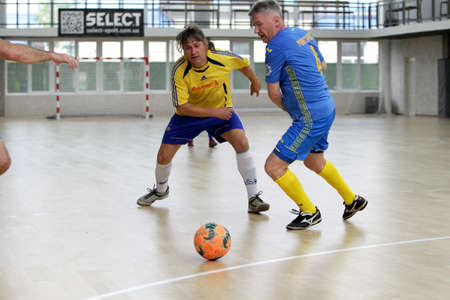 Odessa, Ukraine- May 29, 2020: Cup playoff match match in futsal among veterans 50+. Futsal on large stage of sports hall, covering modern playground. Intense game of mini football in hall. On parquetのeditorial素材