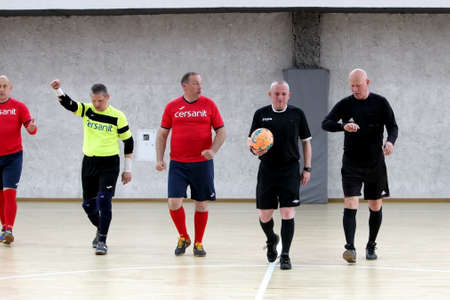 Odessa, Ukraine- May 29, 2020: Cup playoff match match in futsal among veterans 50+. Futsal on large stage of sports hall, covering modern playground. Intense game of mini football in hall. On parquetのeditorial素材
