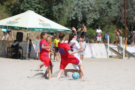 Odessa, Ukraine-July 25, 2020: Beach Soccer Championship among amateur women on beach. Soccer in sand. Young beautiful girls playing beach football on sand of city beach. Football on sandのeditorial素材