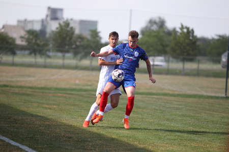 ODESSA, UKRAINE - 07/15/2020 - Fight of football clubs of the first league at the Ukrainian championship. FC BALKANY (Zarya) - FC NIKOLAEV - blue. Game moment while playing big football on the grassのeditorial素材