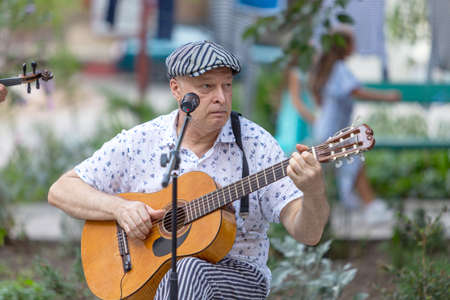 Odessa, Ukraine - CIRCA 2020: Home concert of street musicians in the courtyard of a house during...