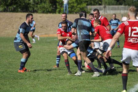 ODESSA, UKRAINE - SEPTEMBER 12, 2020: Final games of strongest rugby-7 teams in Ukrainian championship. Rugby ball on field. Rugby match is tough fight for ball. Athletes team players on fieldのeditorial素材