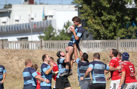 ODESSA, UKRAINE - SEPTEMBER 12, 2020: Final games of strongest rugby-7 teams in Ukrainian championship. Rugby ball on field. Rugby match is tough fight for ball. Athletes team players on fieldのeditorial素材