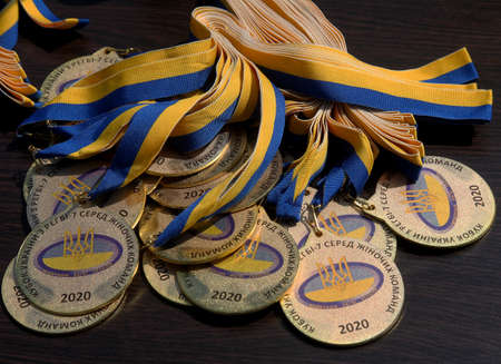 ODESSA, UKRAINE - AUGUST 22, 2020: Official sports awards, medals and cups of the Ukrainian Women's Rugby Championship. Sports awards table for awarding tournament winnersのeditorial素材