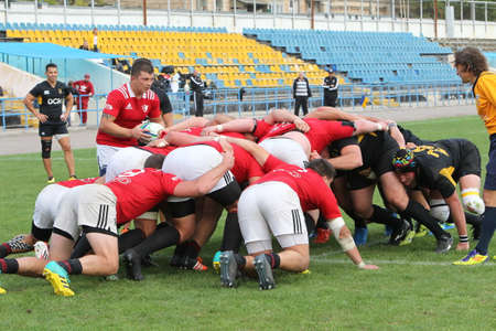 ODESSA, UKRAINE -2020.10.17 - Final of Ukrainian rugby championship CREDO (Odessa) - red, OLYMPIK (Kharkiv) black Intense struggle of rugby players for ball. Dynamic game on green field. Brutal rugbyのeditorial素材