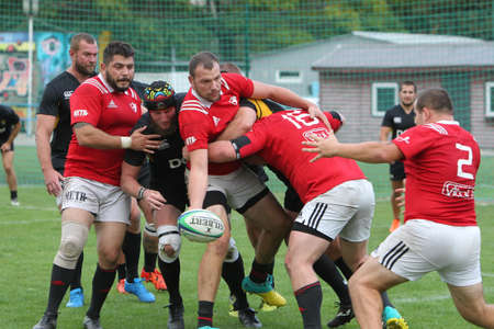 ODESSA, UKRAINE -2020.10.17 - Final of Ukrainian rugby championship CREDO (Odessa) - red, OLYMPIK (Kharkiv) black Intense struggle of rugby players for ball. Dynamic game on green field. Brutal rugbyのeditorial素材