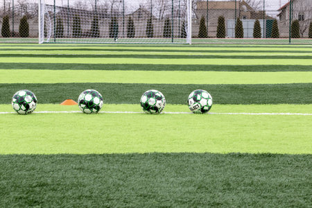 ODESSA, Ukraine - CIRCA 2021: Official soccer ball on artificial green grass on professional soccer field. An outdoor artificial football field with ball, waiting for players to leave and start gameのeditorial素材