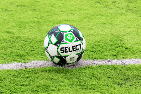 ODESSA, Ukraine - CIRCA 2021: Official soccer ball on artificial green grass on professional soccer field. An outdoor artificial football field with ball, waiting for players to leave and start gameのeditorial素材