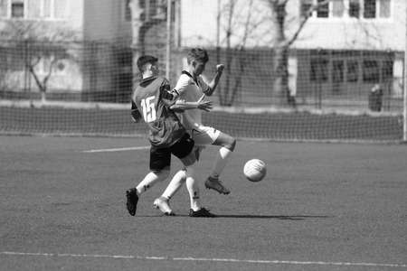 Odessa, Ukraine - April 7, 2021: Local children's football teams U-14 play on artificial grass of stadium. Football on field with artificial grass for soccer games. Children are playing footballのeditorial素材