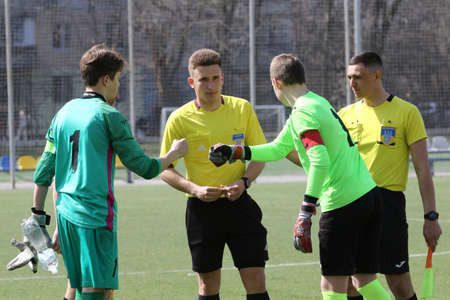 Odessa, Ukraine - April 7, 2021: Local children's football teams U-14 play on artificial grass of stadium. Football on field with artificial grass for soccer games. Children are playing footballのeditorial素材