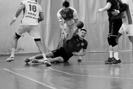 ODESSA, UKRAINE - April 23, 2021: Handball. Federation of Men's Handball of Ukraine. Match Odessa - Motor Sich, Zaporozhye - white. Action during men's handball game. Hard attacking with ballのeditorial素材