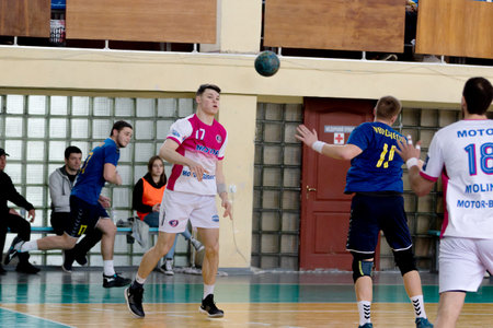 ODESSA, UKRAINE - April 23, 2021: Handball. Federation of Men's Handball of Ukraine. Match Odessa - Motor Sich, Zaporozhye - white. Action during men's handball game. Hard attacking with ballのeditorial素材