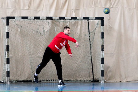 ODESSA, UKRAINE - April 23, 2021: Handball. Federation of Men's Handball of Ukraine. Match Odessa - Motor Sich, Zaporozhye - white. Action during men's handball game. Hard attacking with ballのeditorial素材