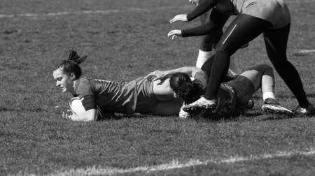 ODESSA, UKRAINE -17 April 2021: Cup of Ukraine among women's rugby teams 7. Odessa - blue, Kiev Aviator - orange. Tense moment of women's rugby match. Dramatic challenging game for women's rugby teamのeditorial素材